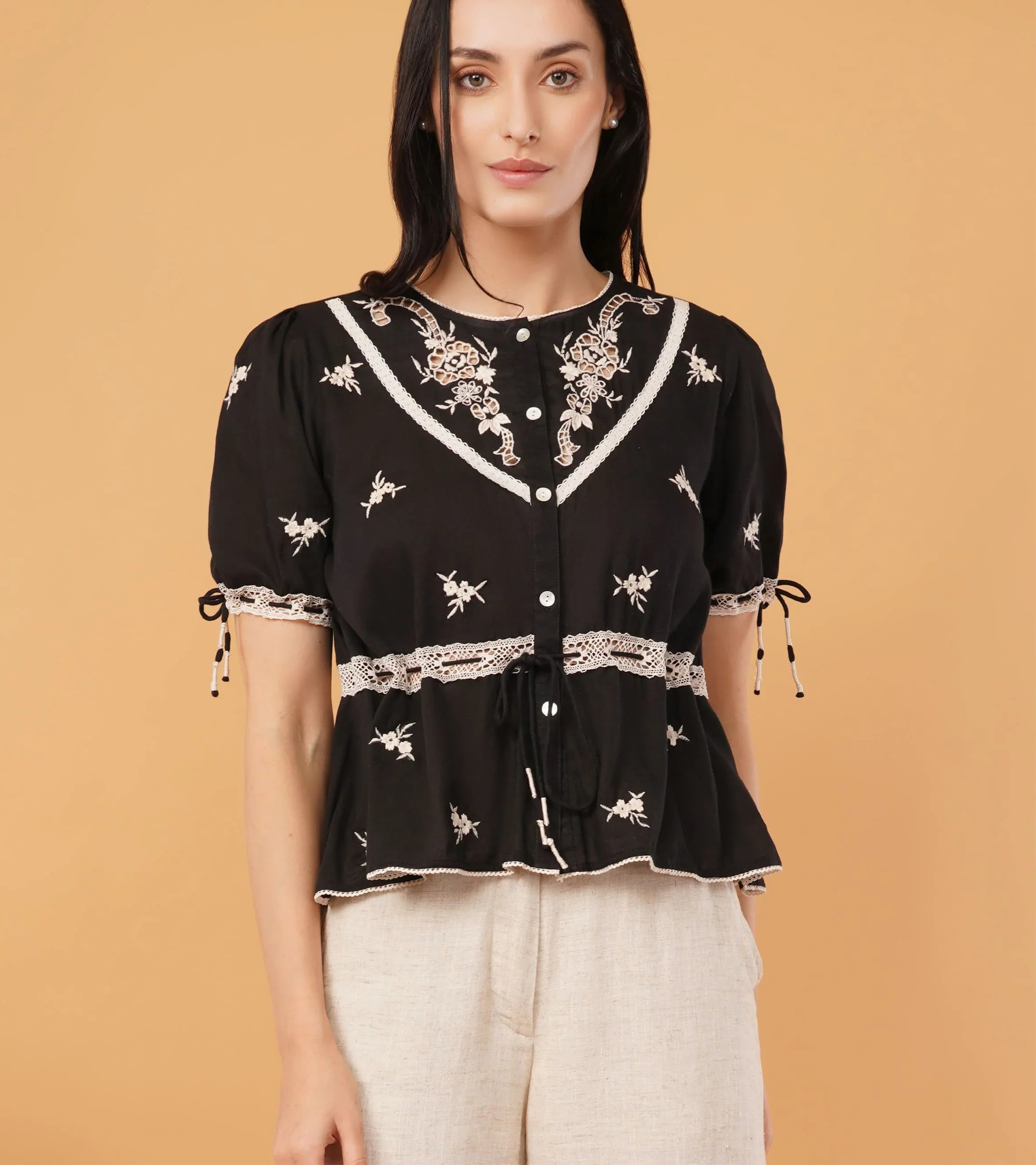 Reverie top featuring a sleek black blouse design, perfect for elegant and formal occasions