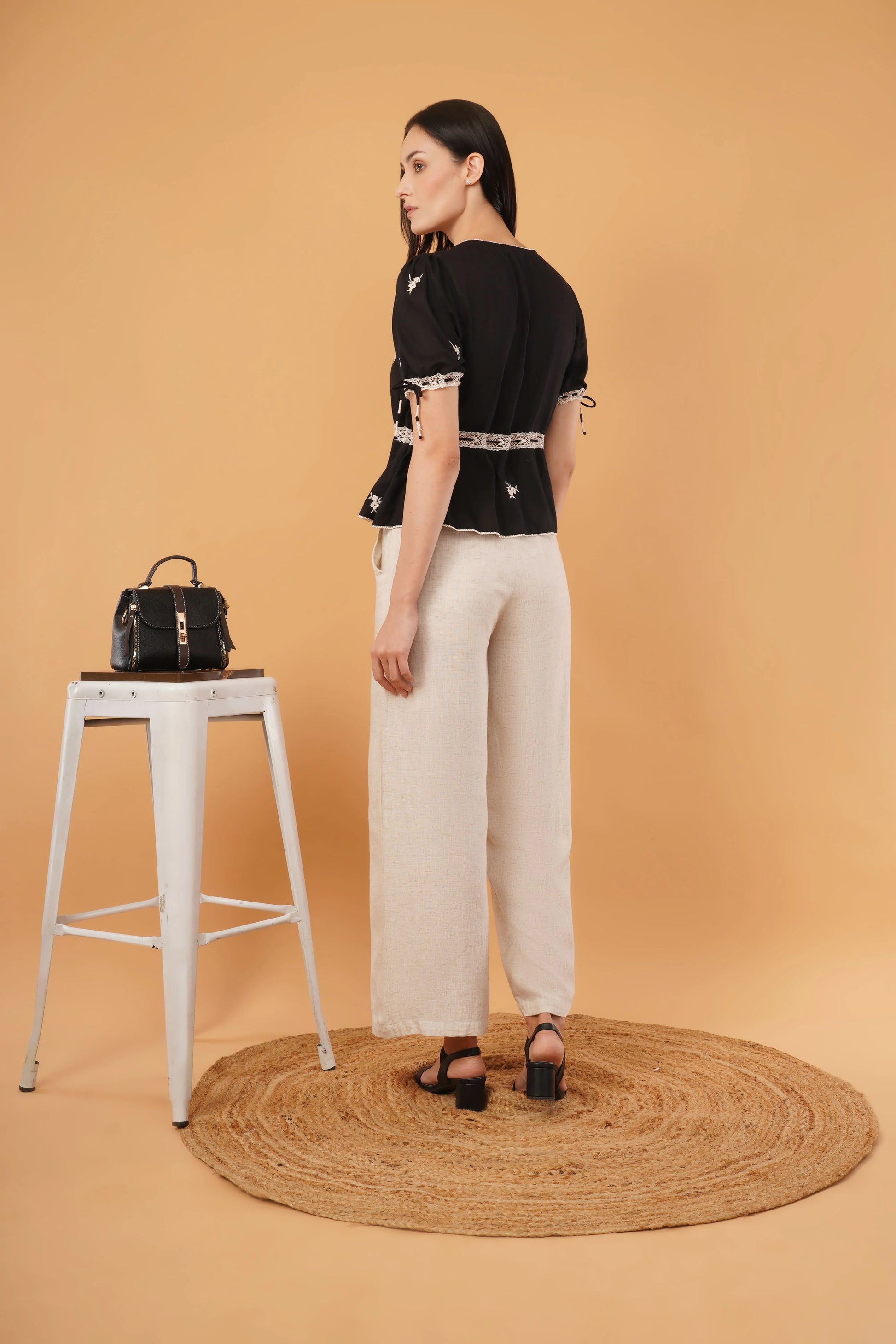 Reverie top featuring a sleek black blouse design, perfect for elegant and formal occasions