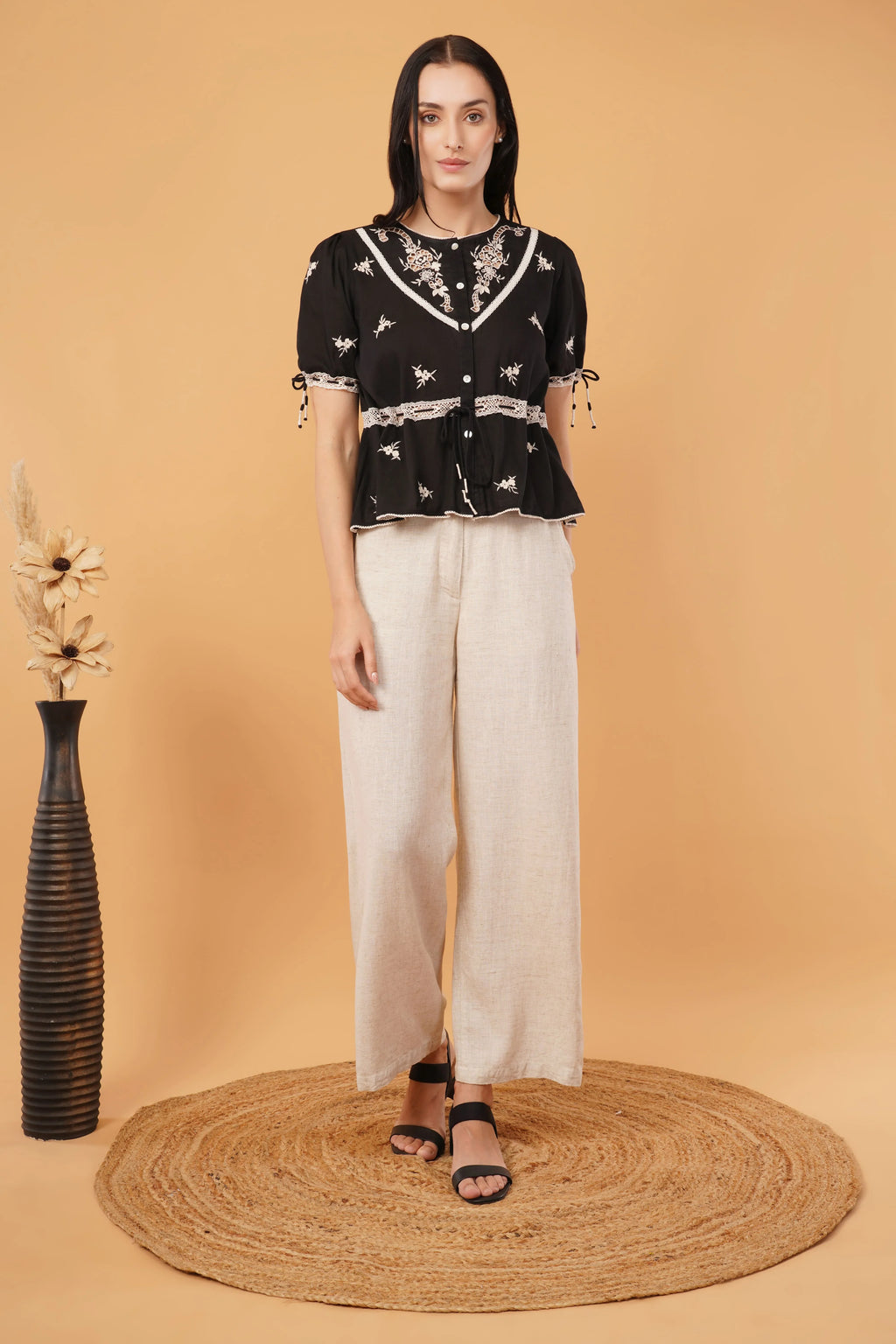 Reverie top featuring a sleek black blouse design, perfect for elegant and formal occasions