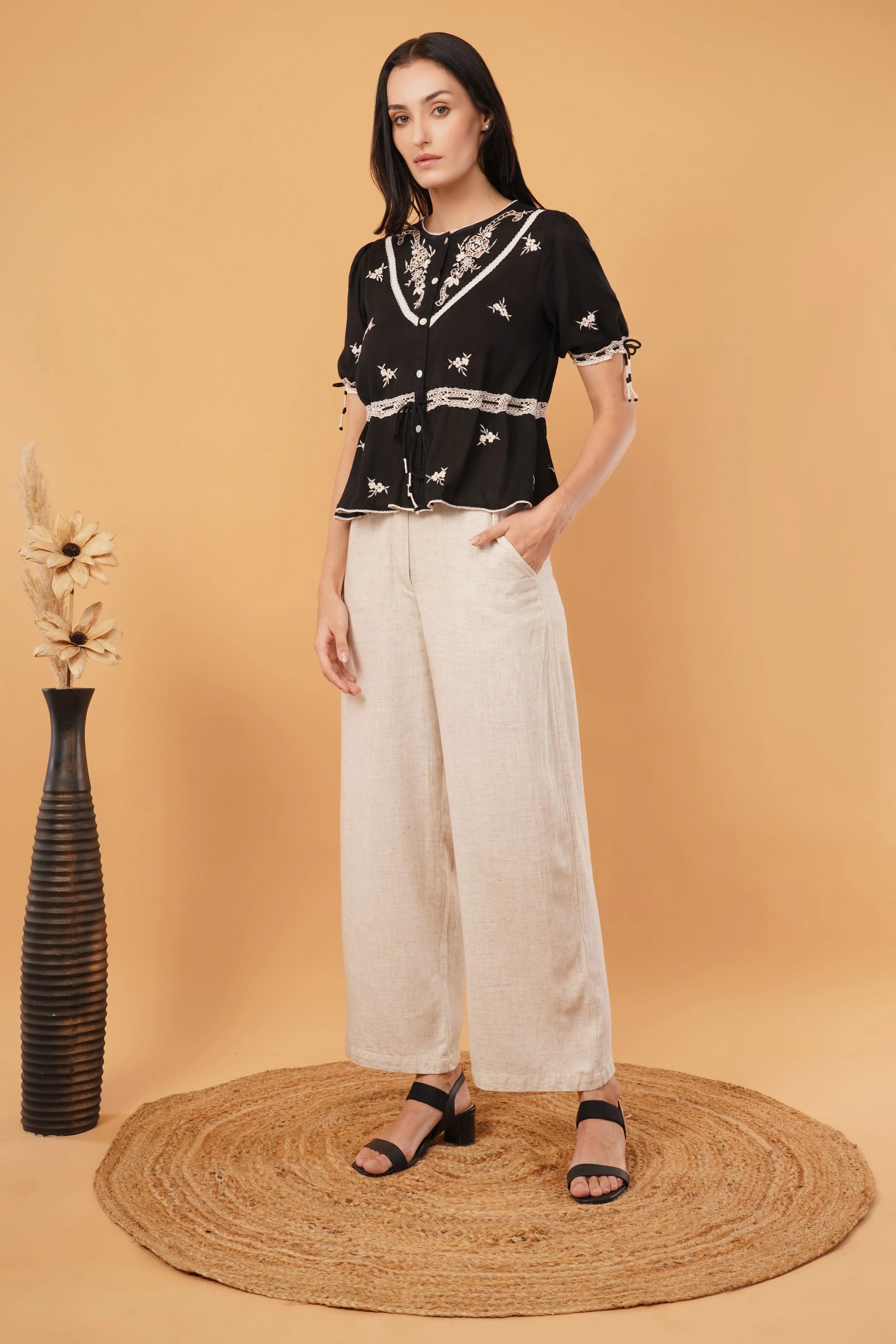 Reverie top featuring a sleek black blouse design, perfect for elegant and formal occasions
