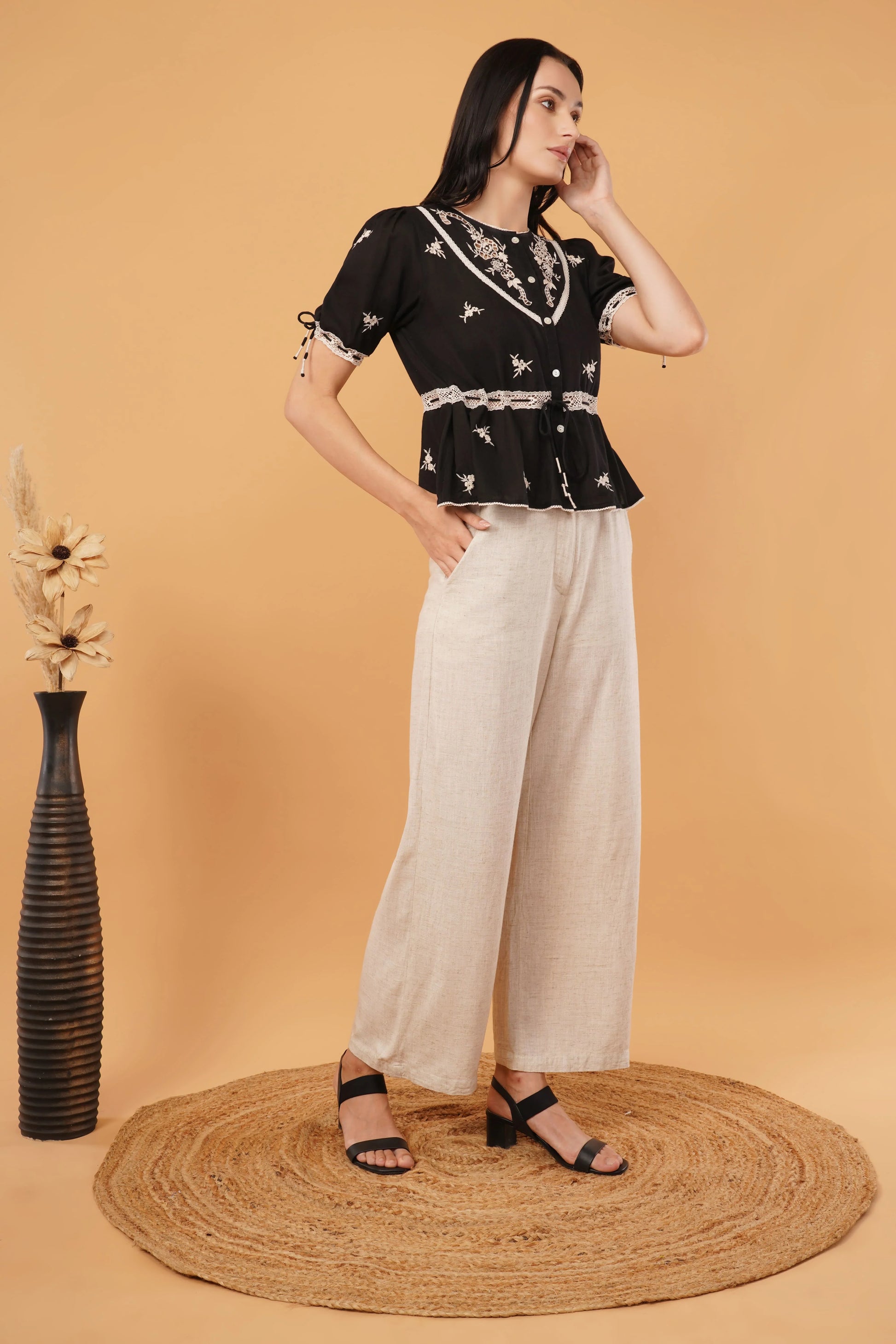 Reverie top featuring a sleek black blouse design, perfect for elegant and formal occasions