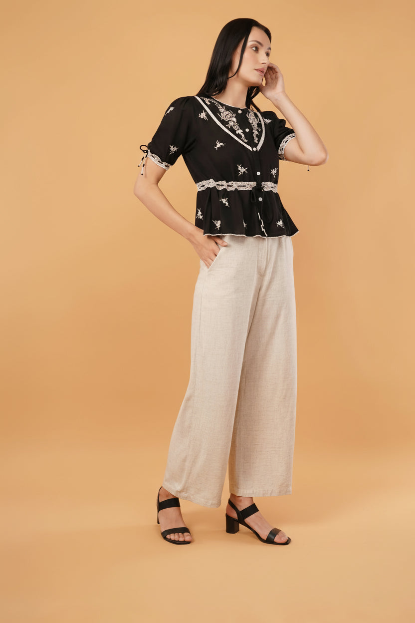 Reverie top featuring a sleek black blouse design, perfect for elegant and formal occasions